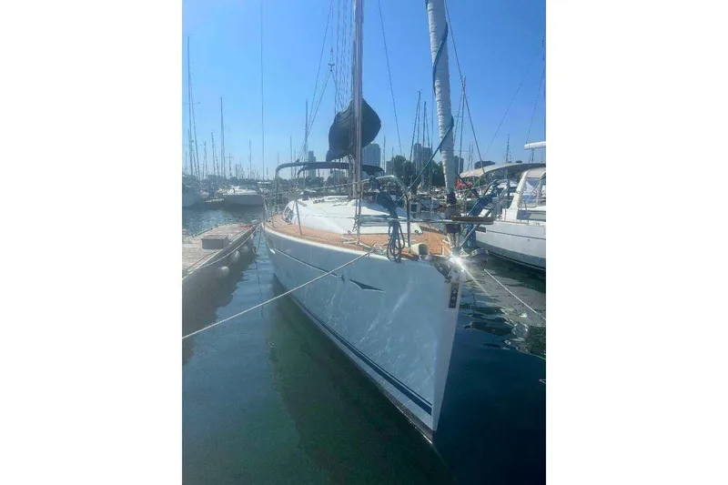 Slide: The Image of 2007 Jeanneau Sun Odyssey 39i sailboat docked in a marina under clear blue skies. - 2