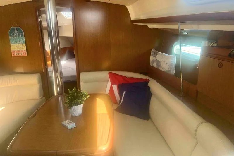 Slide: The Image of Cozy interior of 2007 Jeanneau Sun Odyssey 39i sailboat with seating and decor. - 20