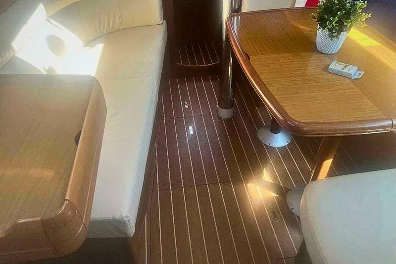 Slide: The Image of Interior of 2007 Jeanneau Sun Odyssey 39i yacht with wooden table and seating. - 21