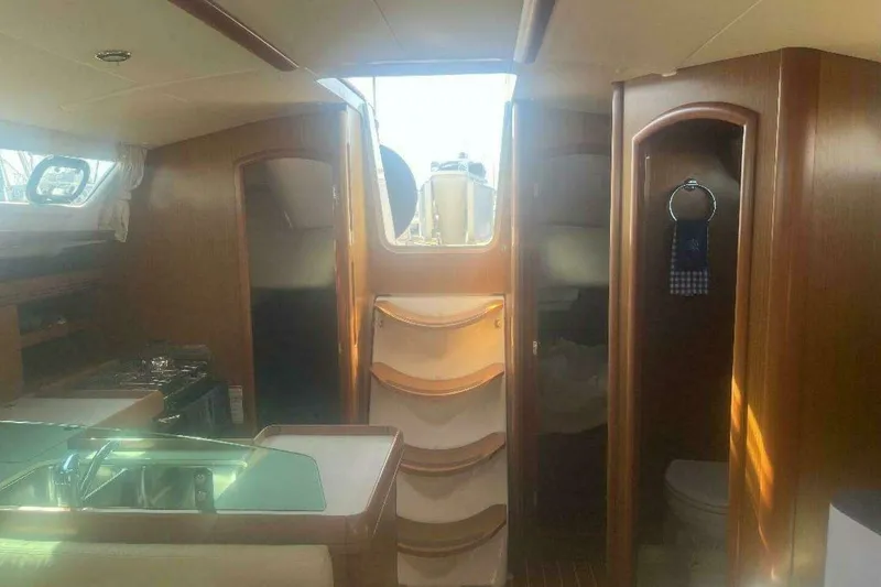 Slide: The Image of Interior of 2007 Jeanneau Sun Odyssey 39i sailboat with wood finish and compact kitchen. - 23