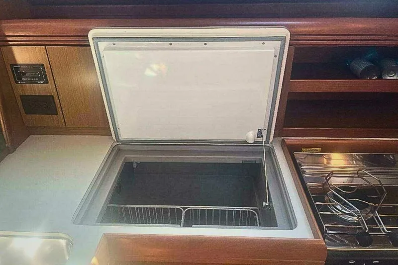 Slide: The Image of 2007 Jeanneau Sun Odyssey 39i yacht kitchen with open fridge and stove. - 25