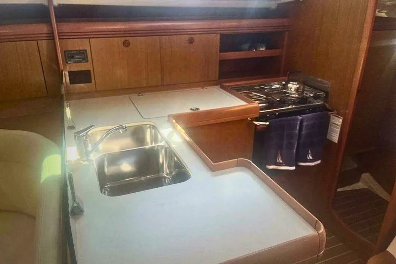Slide: The Image of 2007 Jeanneau Sun Odyssey 39i yacht interior kitchen with sink and stove. - 26