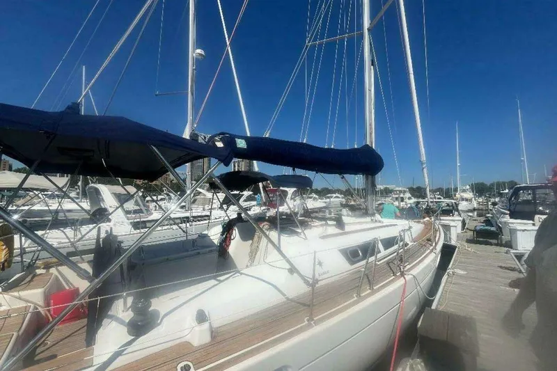Slide: The Image of 2007 Jeanneau Sun Odyssey 39i sailboat docked at a marina under clear blue skies. - 3