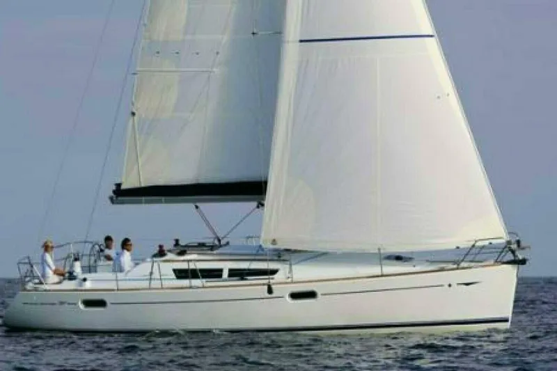 Slide: The Image of 2007 Jeanneau Sun Odyssey 39i sailing on open water with crew onboard. - 36
