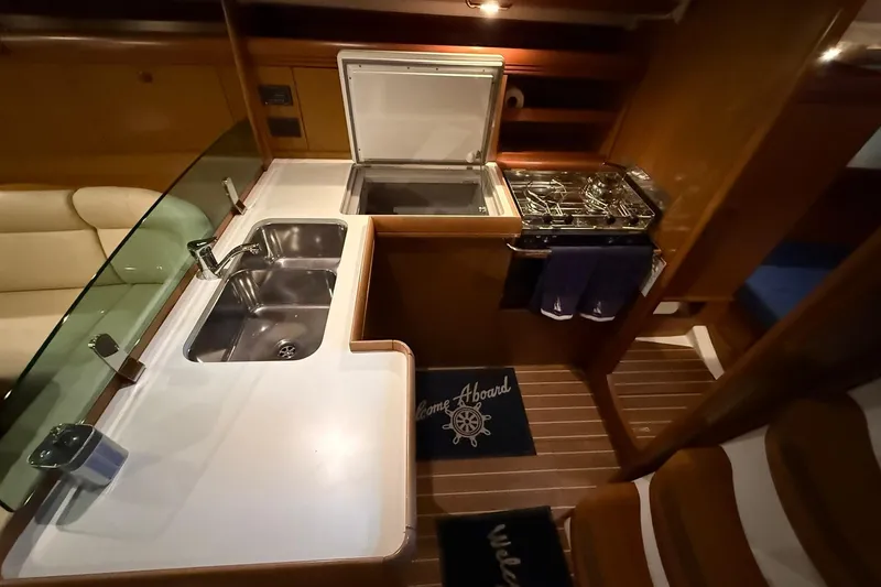 Slide: The Image of 2007 Jeanneau Sun Odyssey 39i yacht kitchen with sink, stove, and cozy interior. - 37