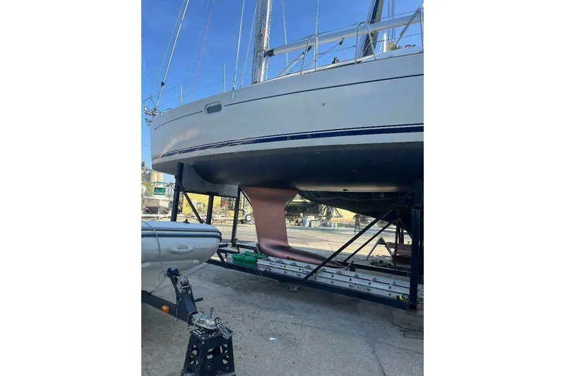 Slide: The Image of 2007 Jeanneau Sun Odyssey 39i sailboat on dry dock, showing hull and keel. - 4