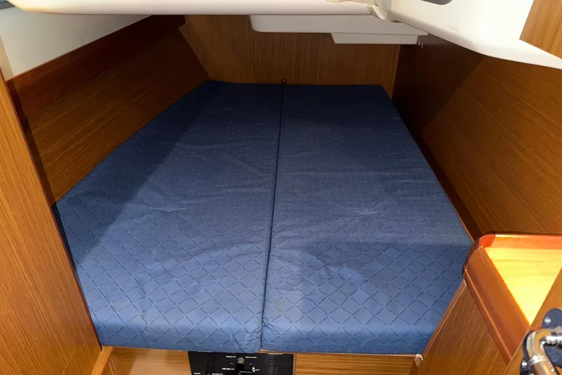 Slide: The Image of 2007 Jeanneau Sun Odyssey 39i cabin interior with blue mattress and wooden finish. - 43