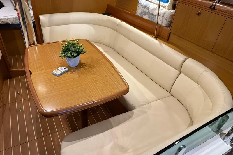 Slide: The Image of Luxurious interior of 2007 Jeanneau Sun Odyssey 39i yacht with elegant seating and table. - 45