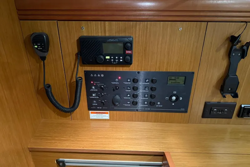 Slide: The Image of Control panel of a 2007 Jeanneau Sun Odyssey 39i sailboat, featuring communication and electrical systems. - 48