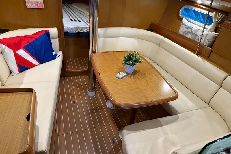 Slide: The Image of Luxurious interior of 2007 Jeanneau Sun Odyssey 39i sailboat with elegant seating and table. - 51