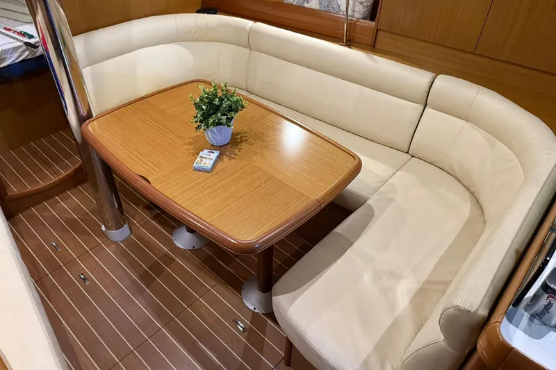 Slide: The Image of Luxurious interior of 2007 Jeanneau Sun Odyssey 39i yacht with elegant seating and table. - 52