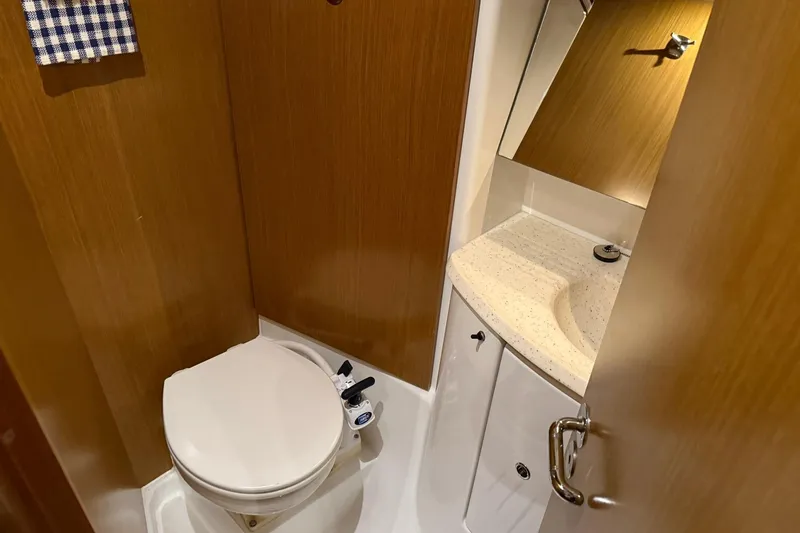 Slide: The Image of Compact bathroom in 2007 Jeanneau Sun Odyssey 39i yacht, featuring toilet and sink. - 54