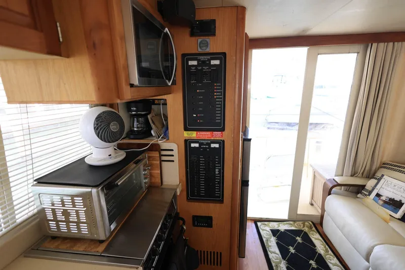 Slide: The Image of Interior of 2005 Mainship 40 Trawler with kitchen appliances and control panel. - 15
