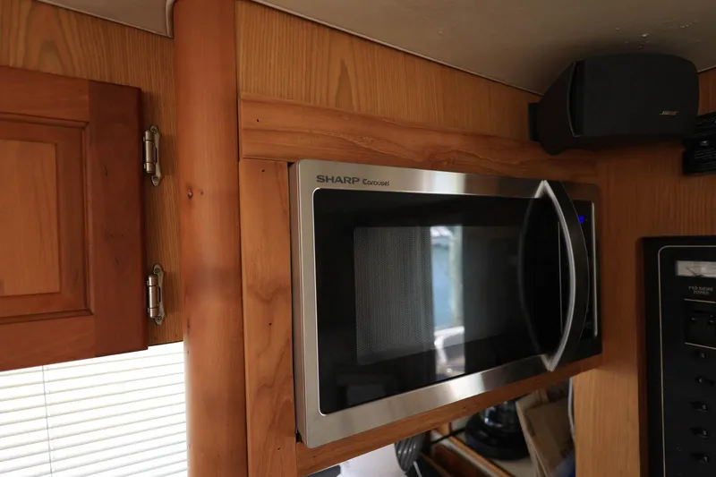 Slide: The Image of Microwave in 2005 Mainship 40 Trawler kitchen, featuring wood cabinetry and modern appliances. - 16