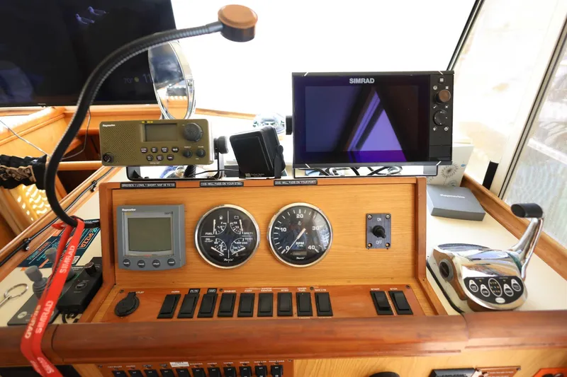 Slide: The Image of Control panel of a 2005 Mainship 40 Trawler with navigation and communication equipment. - 22