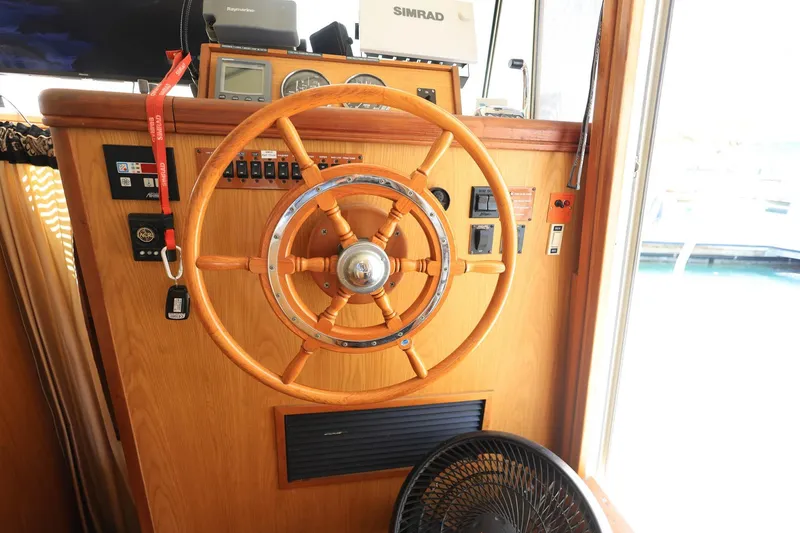 Slide: The Image of Steering wheel of a 2005 Mainship 40 Trawler with navigation equipment. - 23