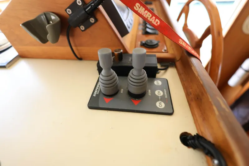 Slide: The Image of Control panel of a 2005 Mainship 40 Trawler with joysticks and Simrad equipment. - 25