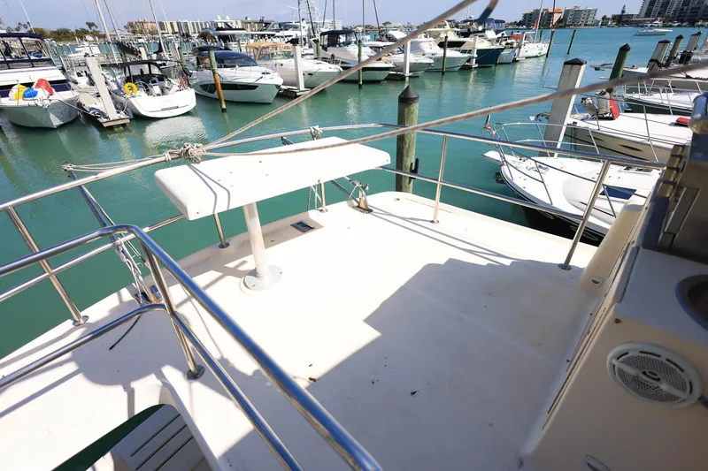 Slide: The Image of 2005 Mainship 40 Trawler deck overlooking marina with multiple boats docked. - 30