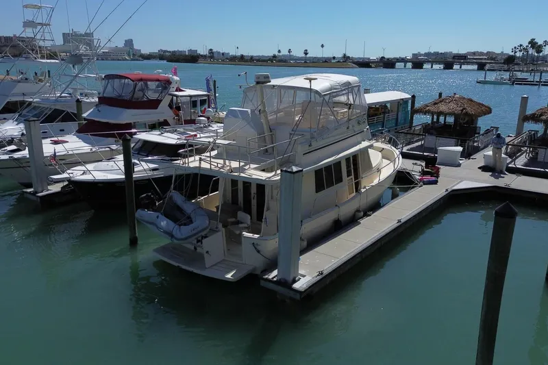 Slide: The Image of 2005 Mainship 40 Trawler docked at marina with clear blue water. - 4