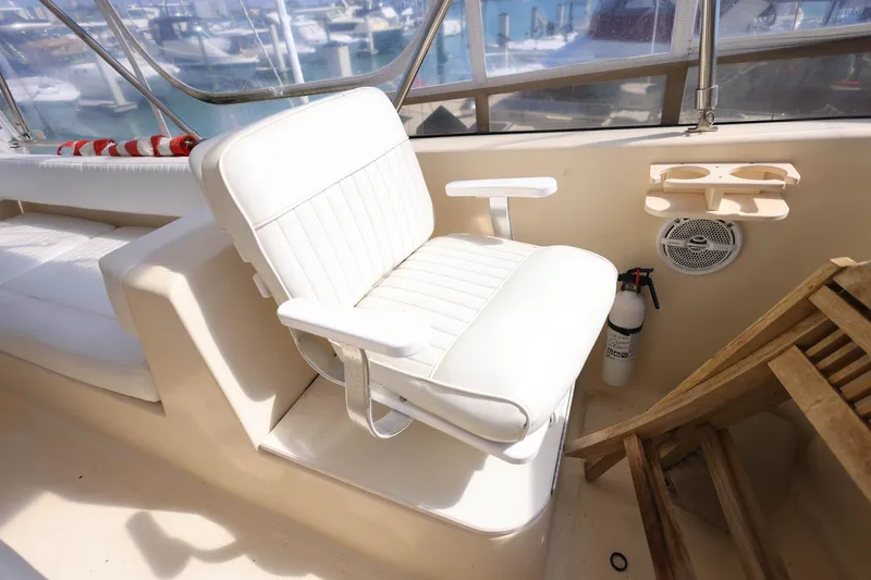 Slide: The Image of Captain's chair on 2005 Mainship 40 Trawler, featuring cup holders and fire extinguisher. - 40