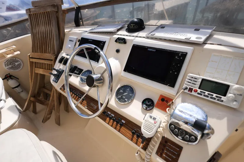 Slide: The Image of 2005 Mainship 40 Trawler helm with steering wheel, navigation equipment, and controls. - 42