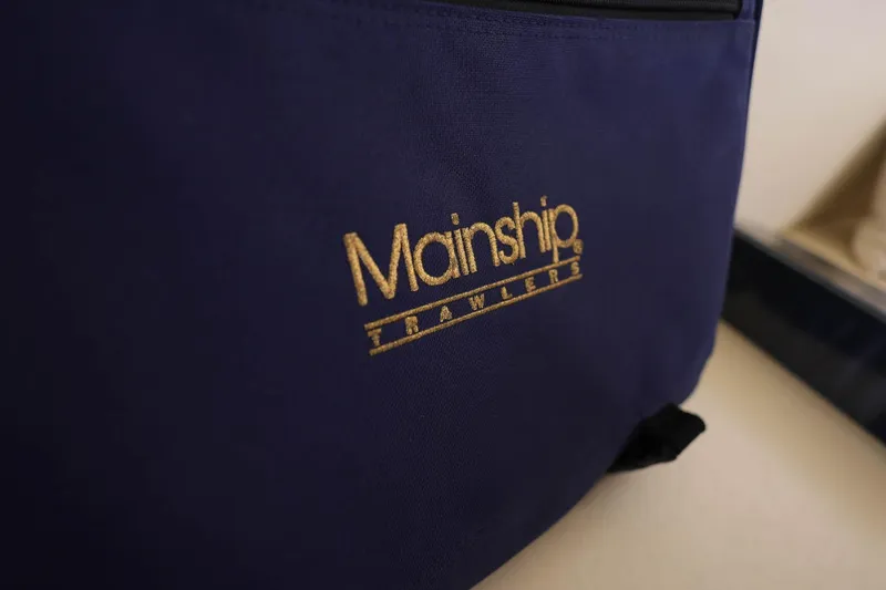 Slide: The Image of Blue fabric with "Mainship Trawlers" logo, related to 2005 Mainship 40 Trawler. - 47