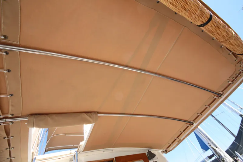 Slide: The Image of 1983 Grand Banks 32 Sedan boat canopy with metal supports, viewed from below. - 14