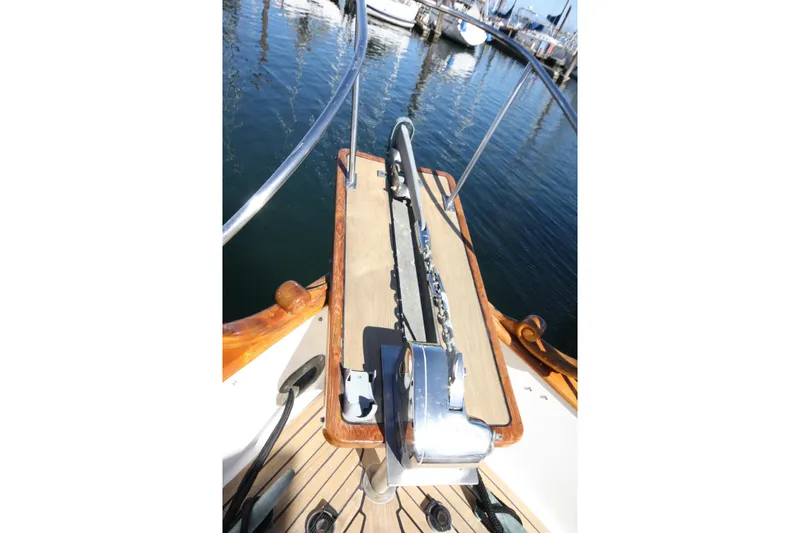 Slide: The Image of 1983 Grand Banks 32 Sedan boat deck with anchor chain and railing, docked in marina. - 16