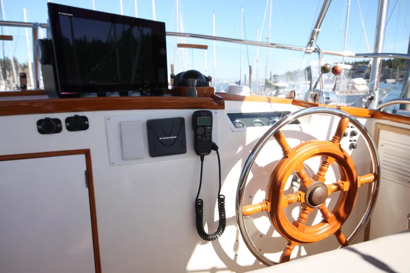 Slide: The Image of Helm of 1983 Grand Banks 32 Sedan with wooden steering wheel and navigation equipment. - 21