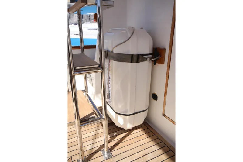 Slide: The Image of 1983 Grand Banks 32 Sedan boat deck with mounted white storage container. - 24