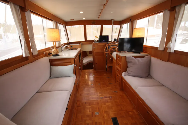 Slide: The Image of Interior of 1983 Grand Banks 32 Sedan with cozy seating and wooden finishes. - 25