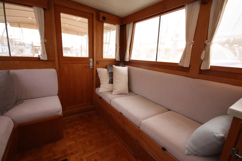 Slide: The Image of Interior of 1983 Grand Banks 32 Sedan with cozy seating and wooden accents. - 26