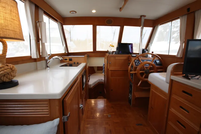 Slide: The Image of Interior of 1983 Grand Banks 32 Sedan boat with wooden cabinetry and helm station. - 28