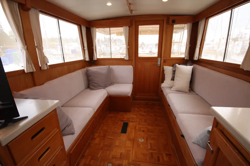 Slide: The Image of Interior of 1983 Grand Banks 32 Sedan with cozy seating and wooden finishes. - 29