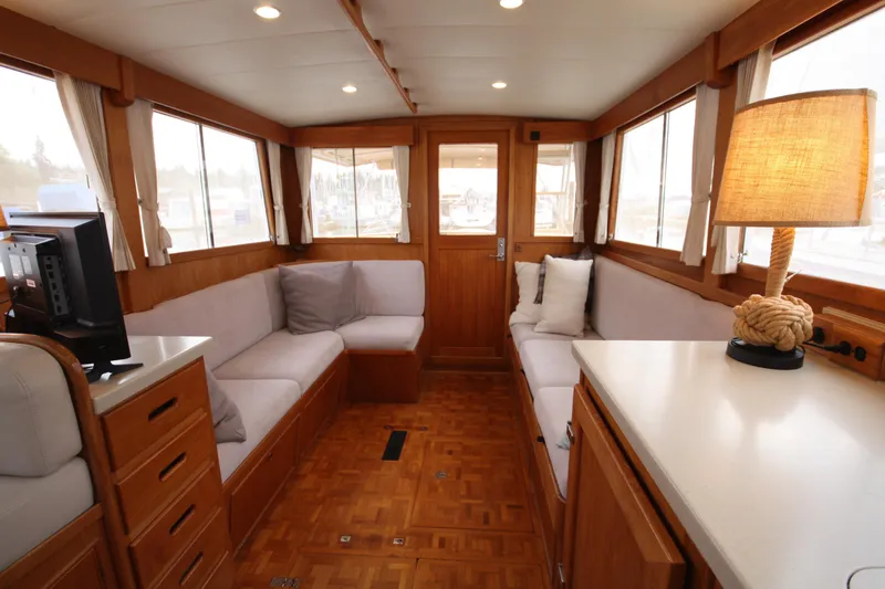 Slide: The Image of Interior of 1983 Grand Banks 32 Sedan with cozy seating and nautical decor. - 30