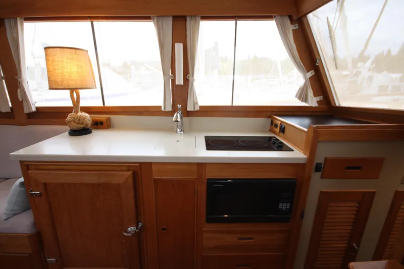 Slide: The Image of Interior of 1983 Grand Banks 32 Sedan with kitchenette and nautical decor. - 35