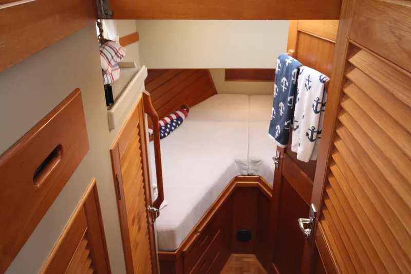 Slide: The Image of Cozy cabin interior of 1983 Grand Banks 32 Sedan with nautical decor and wooden finishes. - 36