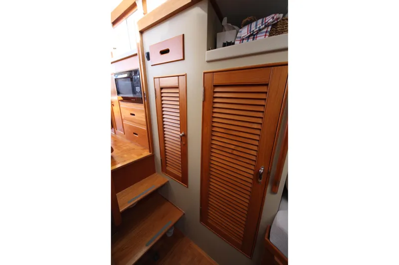 Slide: The Image of Interior of 1983 Grand Banks 32 Sedan with wooden cabinetry and stairs. - 37