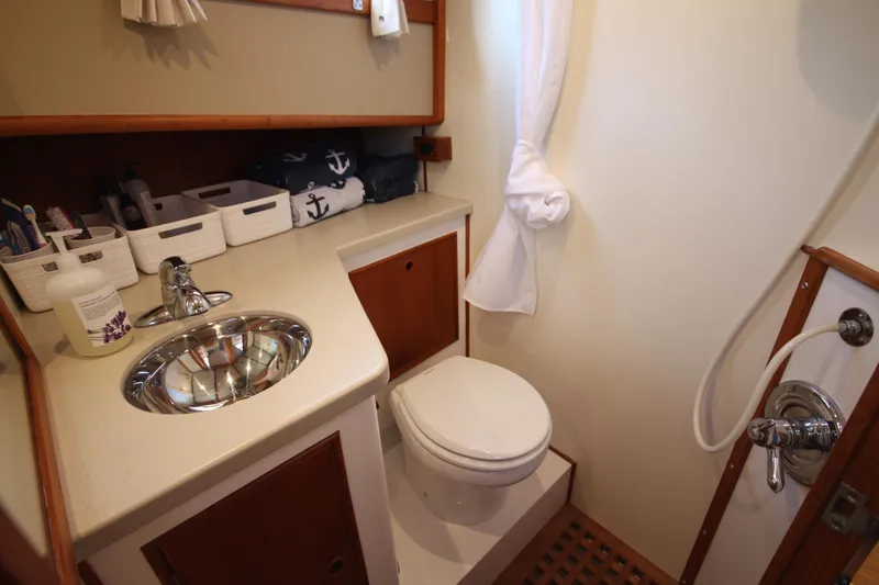 Slide: The Image of 1983 Grand Banks 32 Sedan bathroom with sink, toilet, and shower. - 39