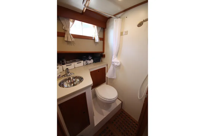 Slide: The Image of Bathroom interior of 1983 Grand Banks 32 Sedan yacht, featuring sink and toilet. - 40