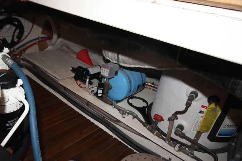 Slide: The Image of Engine room of 1983 Grand Banks 32 Sedan with visible plumbing and equipment. - 54