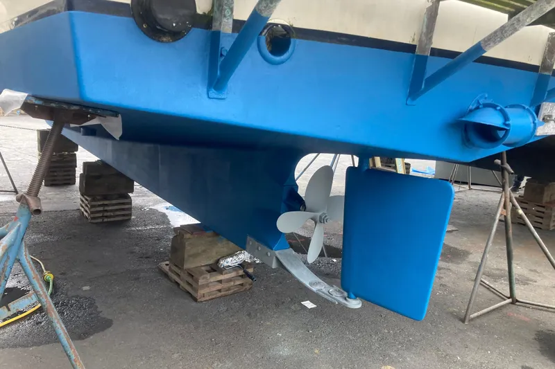 Slide: The Image of 1983 Grand Banks 32 Sedan boat hull with blue paint, propeller, and rudder visible. - 55