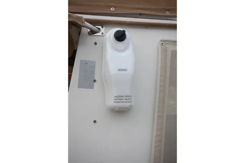 Slide: The Image of Battery-operated device mounted on a 1983 Grand Banks 32 Sedan boat interior. - 59