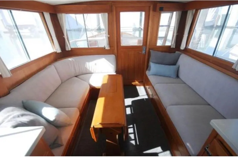 Slide: The Image of Interior of 1983 Grand Banks 32 Sedan with cozy seating and wooden accents. - 62