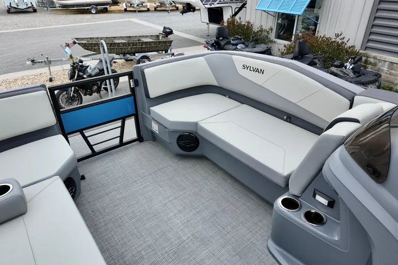 Slide: The Image of Interior of 2026 Sylvan A-22 LZ DH SPORT boat with gray seating and cup holders. - 18
