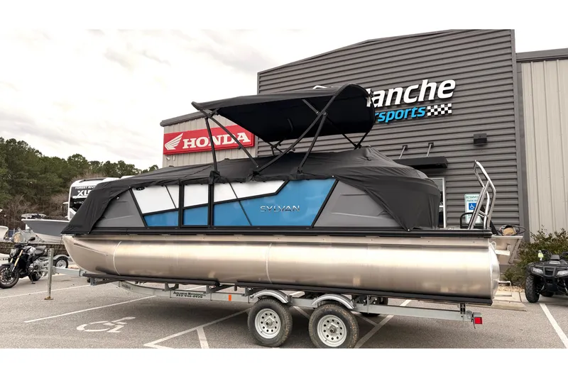 Slide: The Image of 2026 Sylvan A-22 LZ DH SPORT pontoon boat on trailer at dealership. - 23