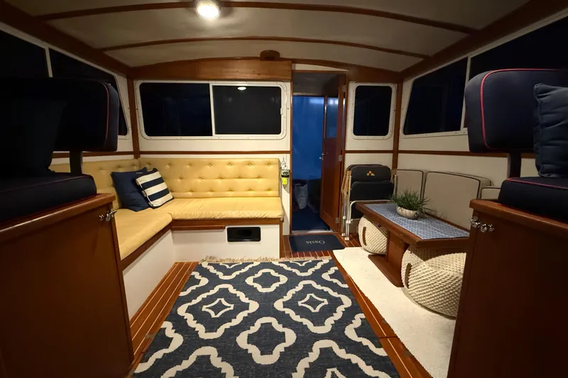 Slide: The Image of Interior of 1987 Wilbur 38 boat with cozy seating and nautical decor. - 16