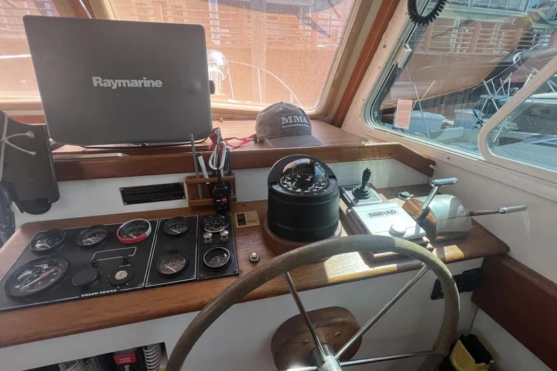 Slide: The Image of Helm of 1987 Wilbur 38 boat with Raymarine equipment and navigational controls. - 18