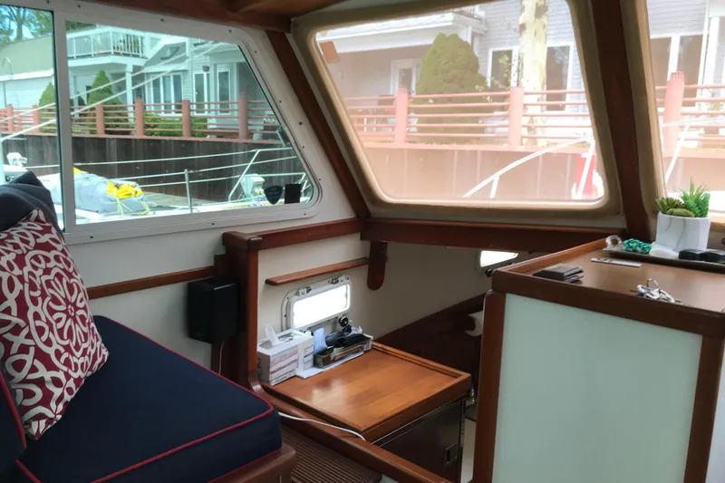 Slide: The Image of Interior of 1987 Wilbur 38 boat with cozy seating and nautical decor. - 19