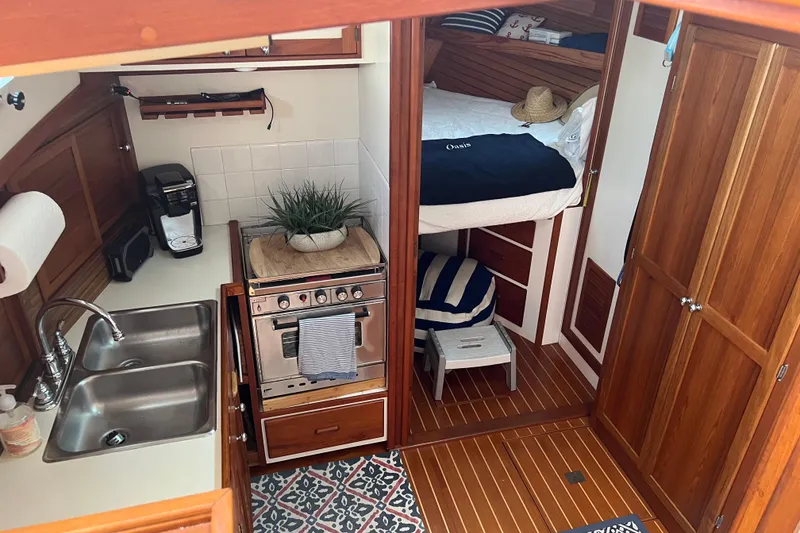 Slide: The Image of Cozy 1987 Wilbur 38 yacht interior with kitchen, sink, stove, and bed. - 20